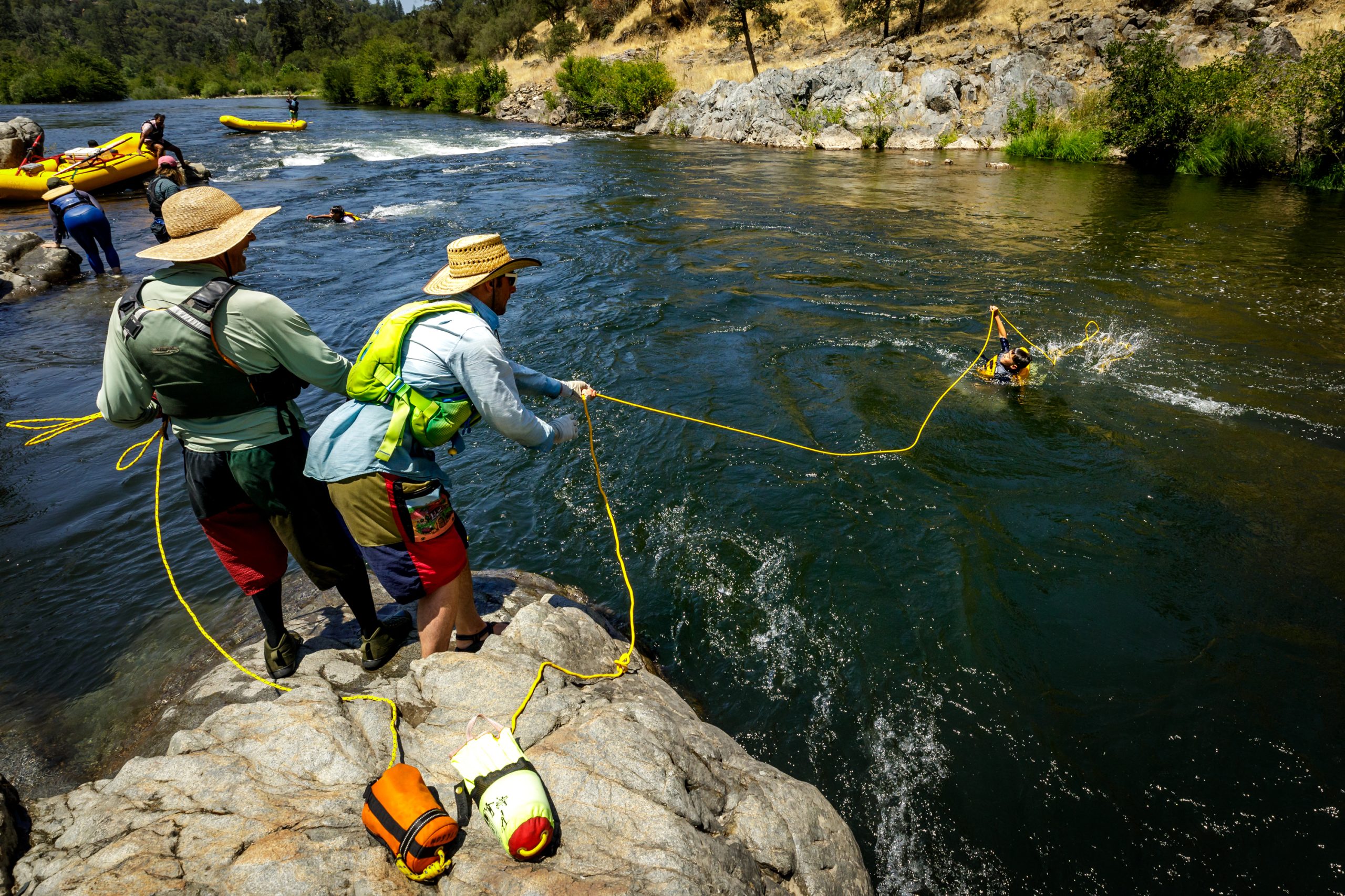 Rafting instructors and youth guides practice whitewater safety maneuvers